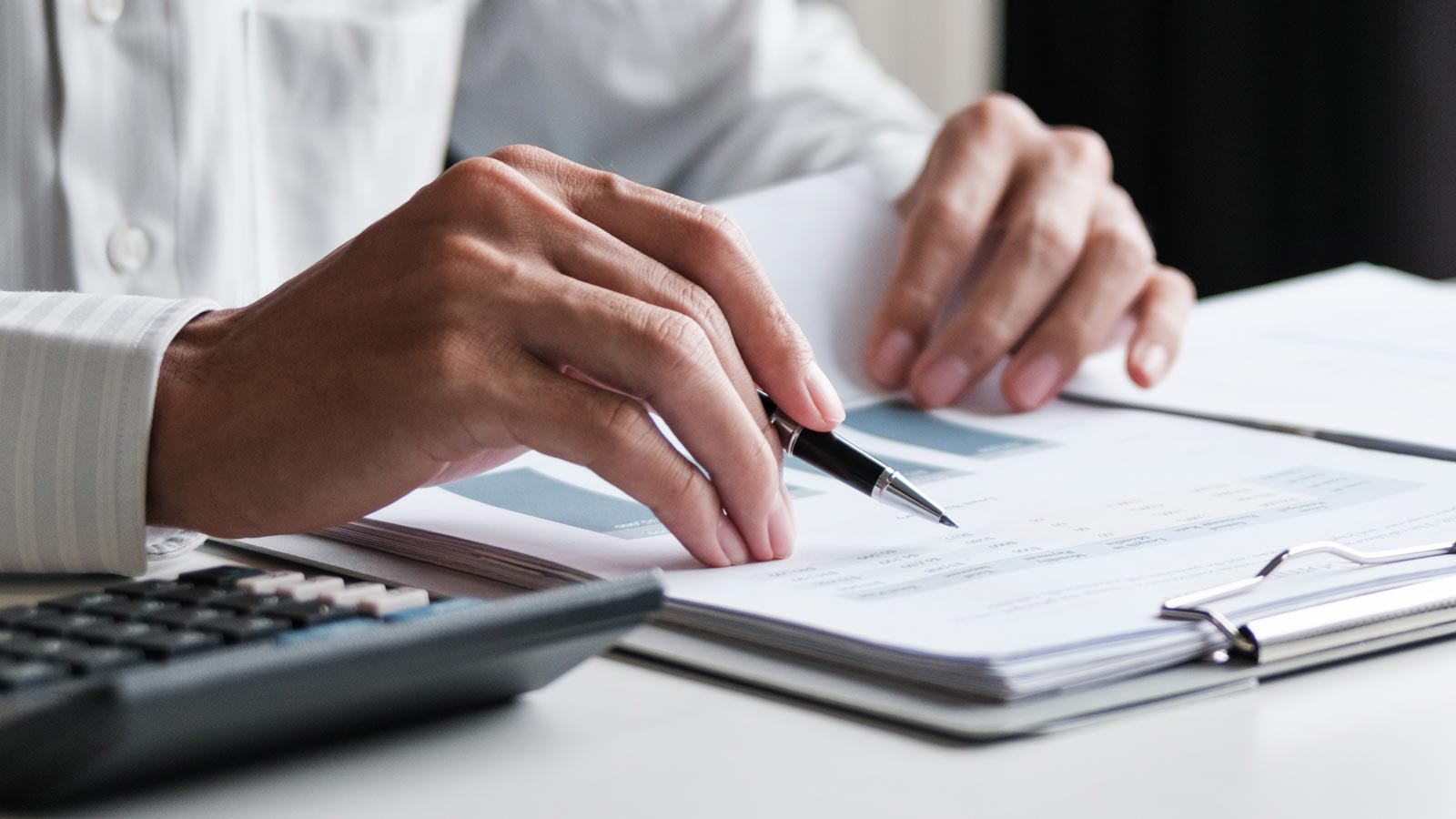 Accountant reviewing financial statements and documents during an ATO audit.