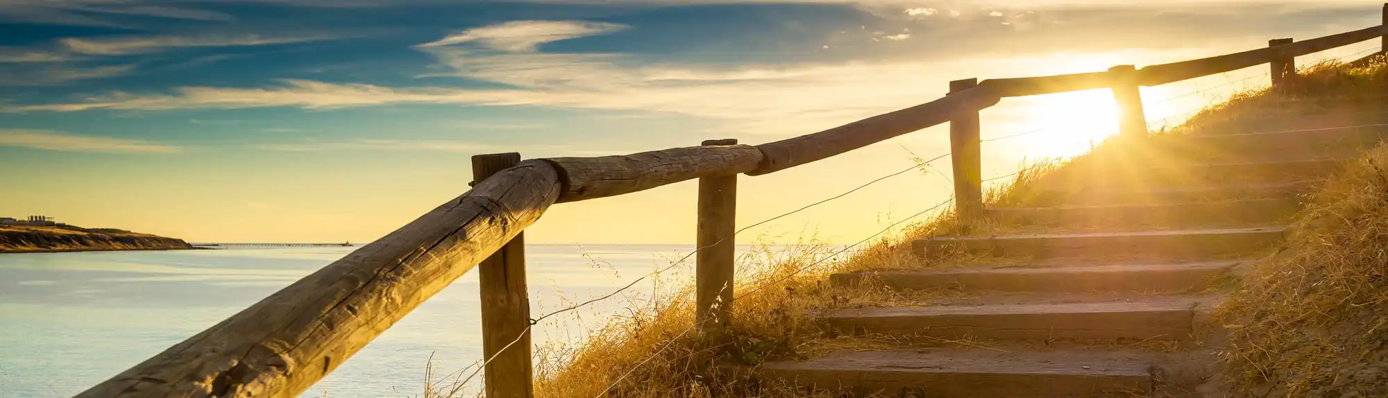 Sunrise over coastal steps on the Sunshine Coast, representing Holmans’ trusted accounting and business support.