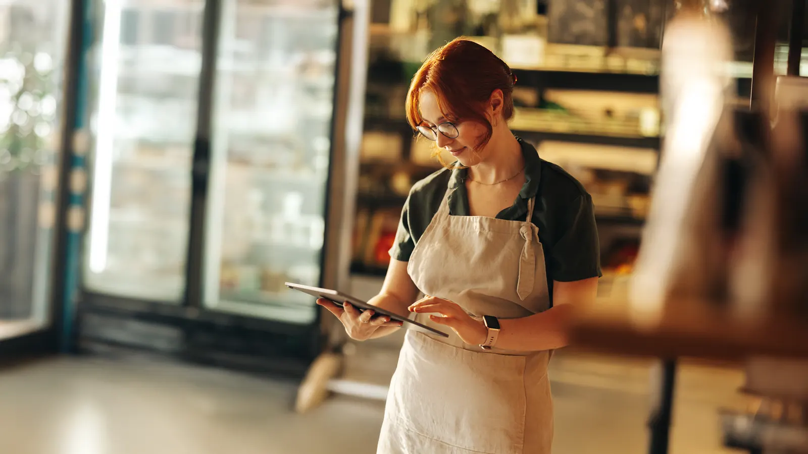 Small business owner reviewing finances on tablet Sunshine Coast tax planning