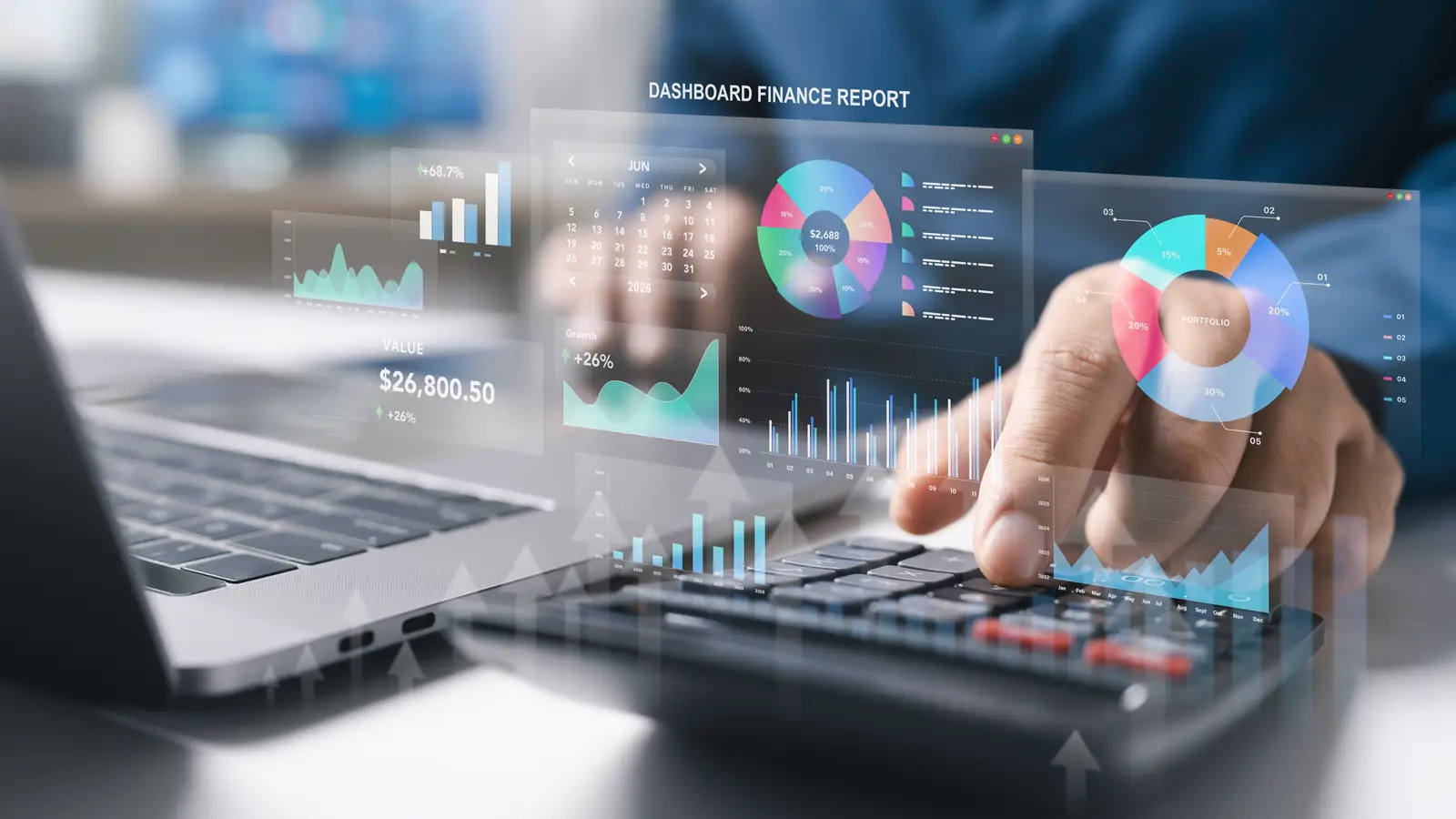 Accountant using a calculator beside a laptop with digital financial charts overlaid.